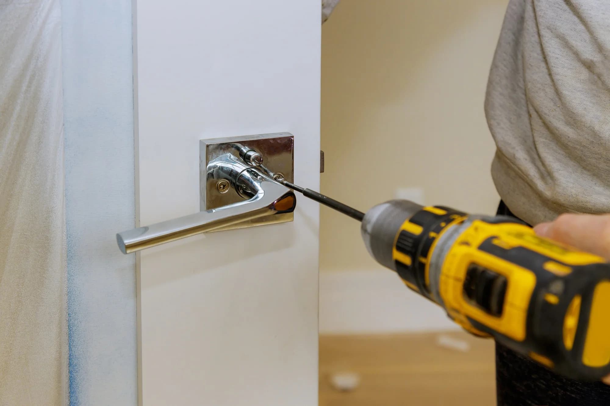Carpenter installing door lock